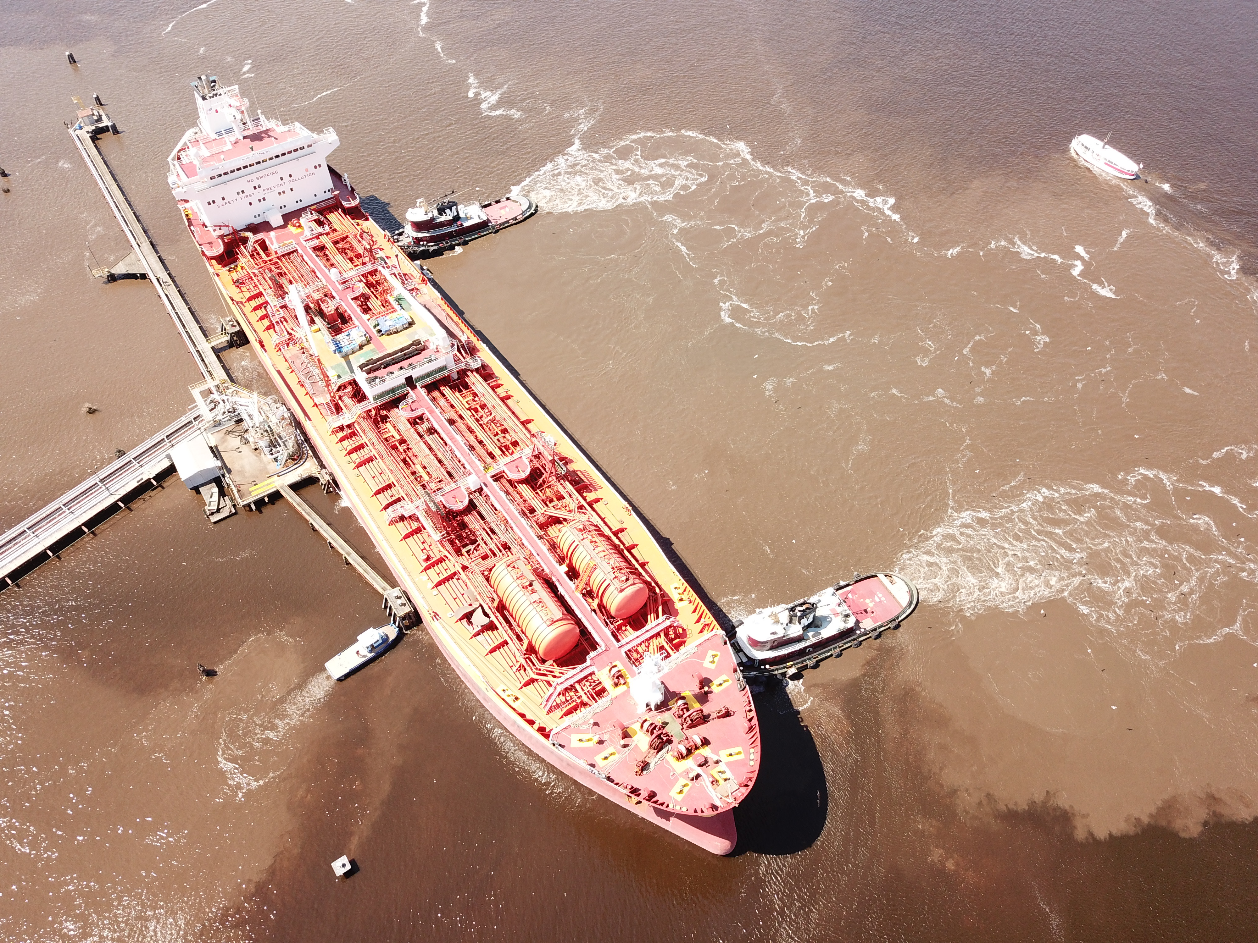 Product tanker under tug assistance on approach to a terminal